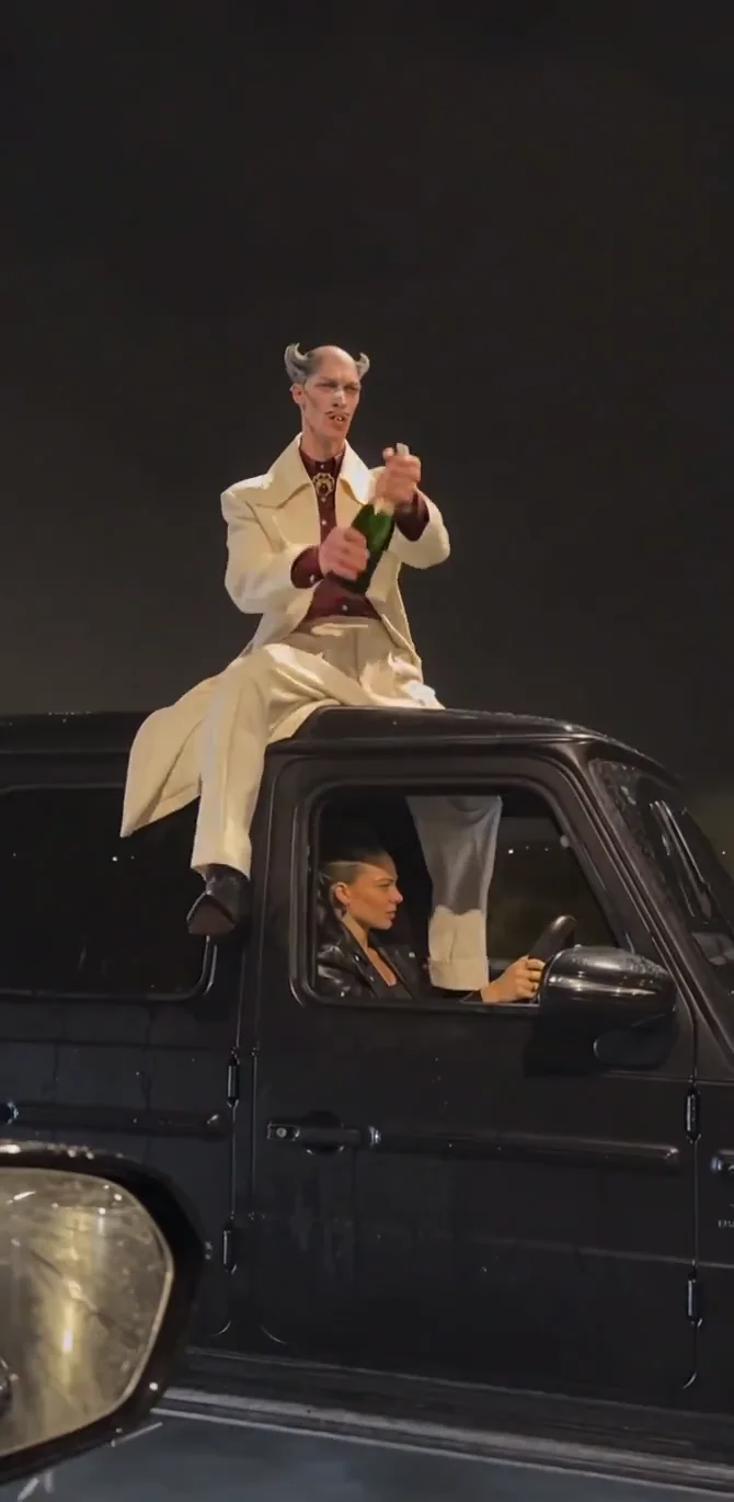 Cream suit, burgundy shirt · car roof · 9 s · with sound