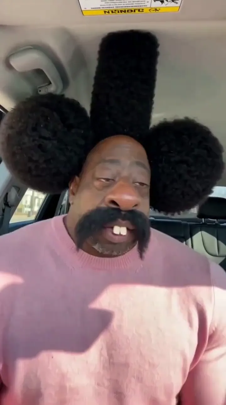 Pink sweater, tall afro cartoon face · 10 s · with the chant